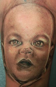 Aaaaaah! Some alien thing is coming out of your leg!! Oh wait...it's just another hideous baby tattoo.